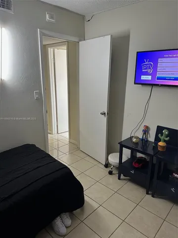 a bedroom with a bed and cabinets