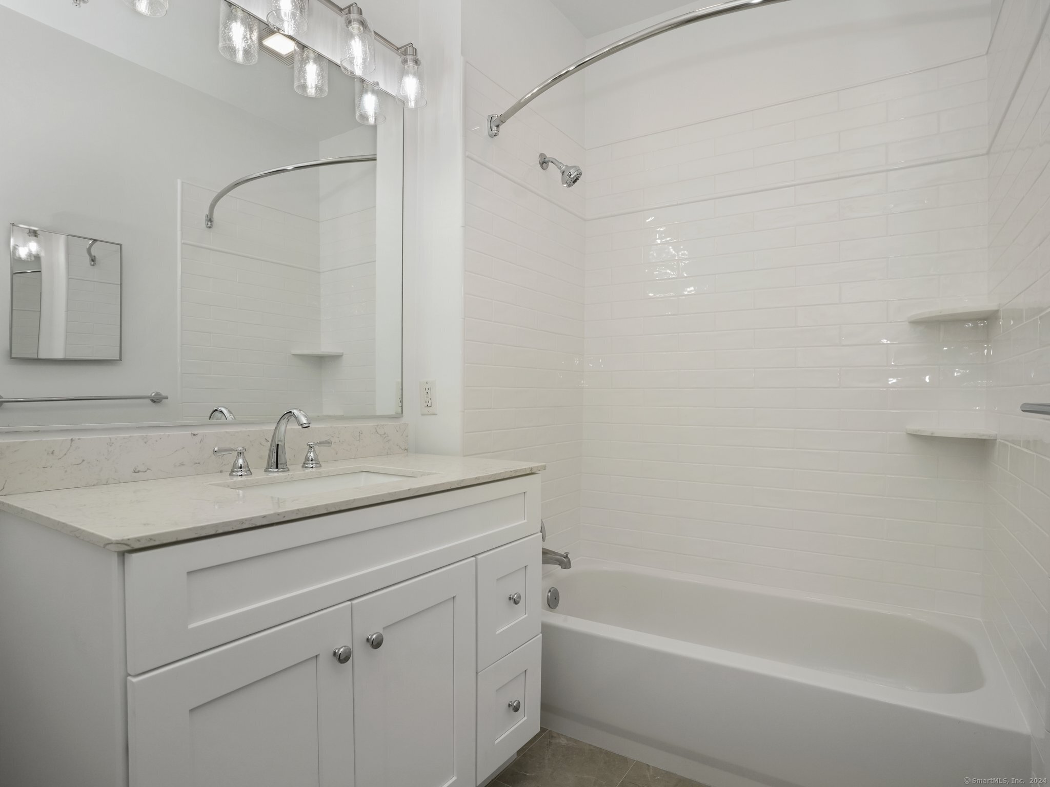 35 West Broad Street, Unit 211 Stamford, CT 06902 - Photo 11 of 38 a bathroom with a granite countertop sink a toilet and shower