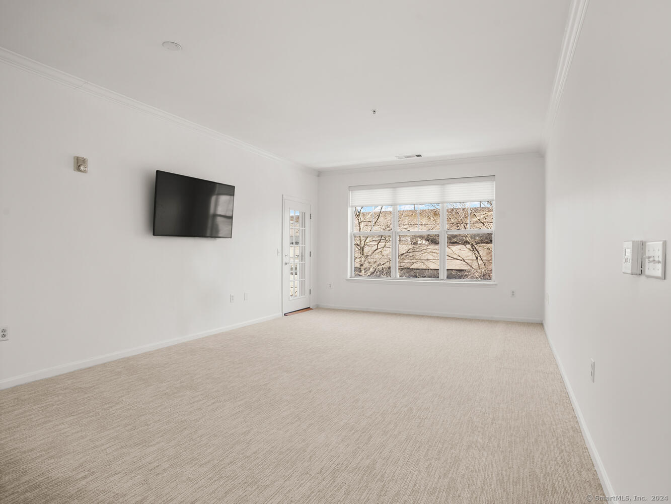 35 West Broad Street, Unit 211 Stamford, CT 06902 - Photo 9 of 38 an empty room with windows and fireplace