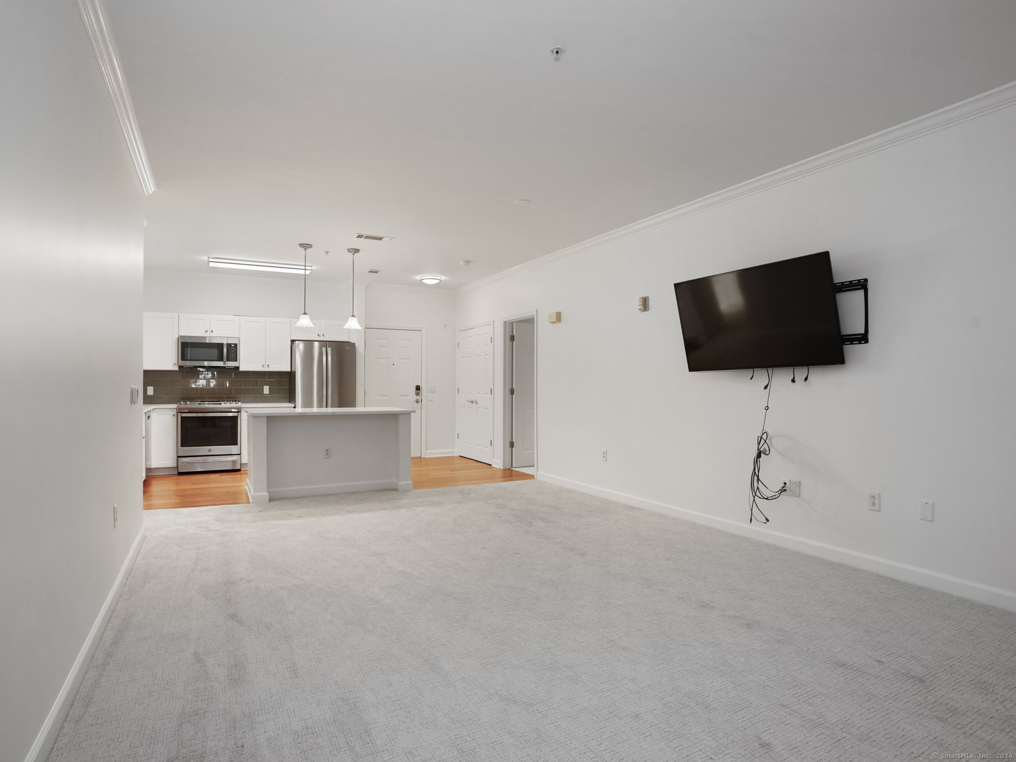 35 West Broad Street, Unit 211 Stamford, CT 06902 - Photo 10 of 38 a view of a kitchen with microwave and cabinets