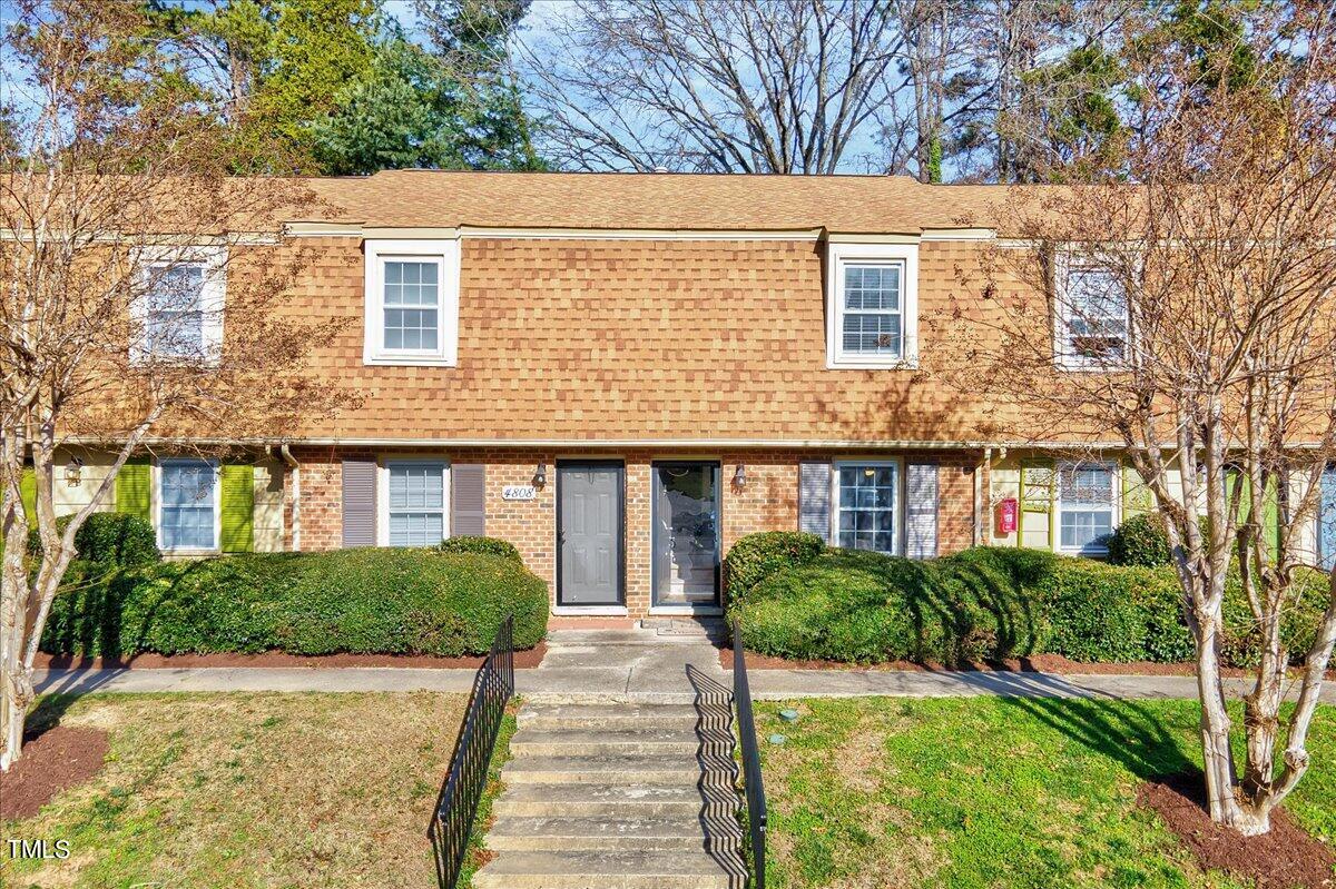 4808 Blue Bird Court, Unit D Raleigh, NC 27606 - Photo 1 of 31 a front view of a house with garden