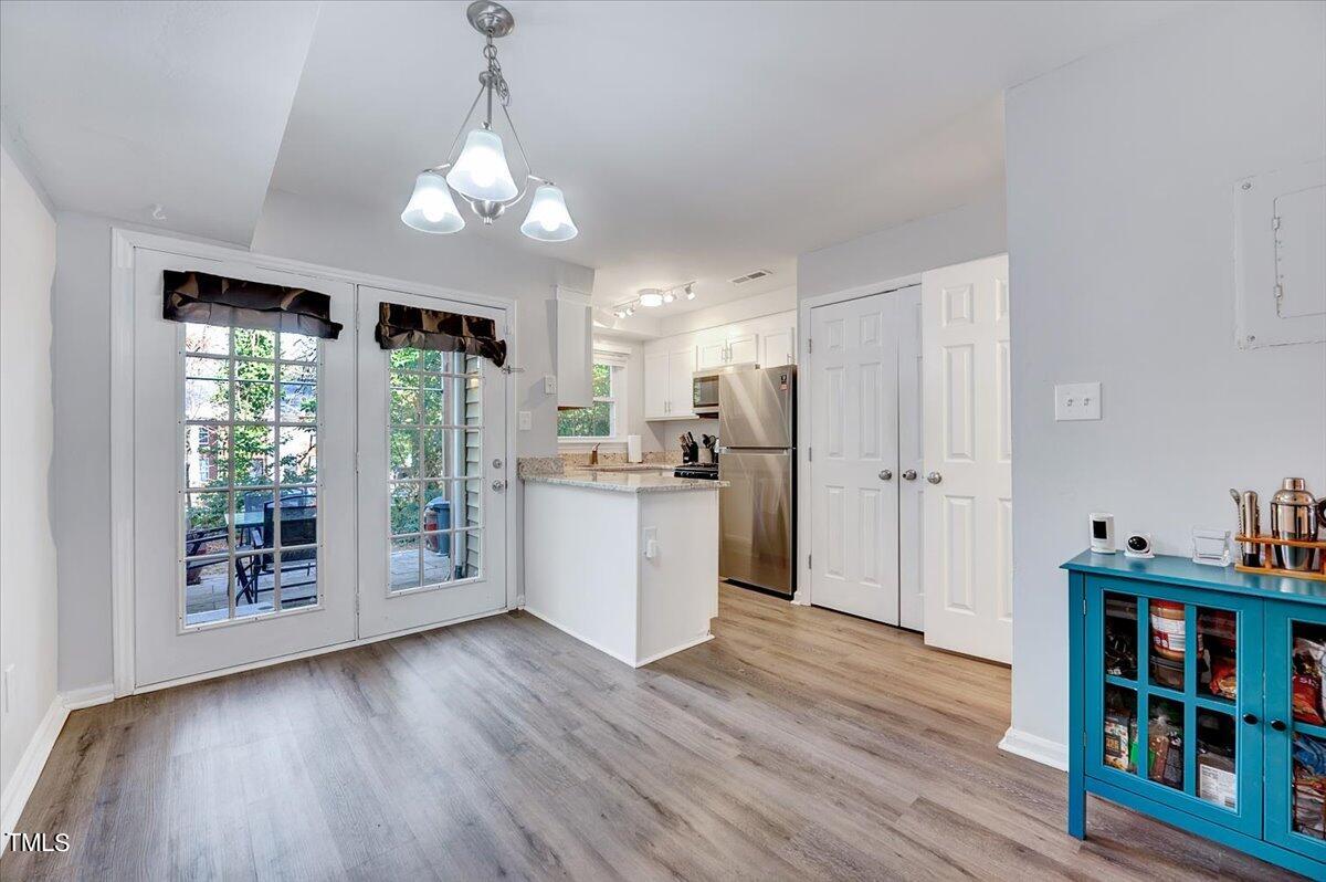4808 Blue Bird Court, Unit D Raleigh, NC 27606 - Photo 11 of 31 a view of a kitchen with fridge and wooden floor