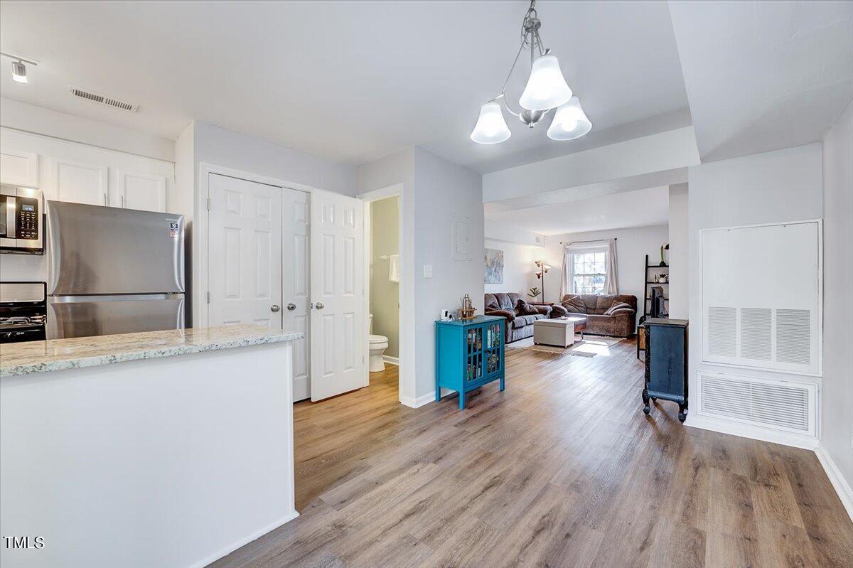4808 Blue Bird Court, Unit D Raleigh, NC 27606 - Photo 12 of 31 a living room with furniture and a chandelier