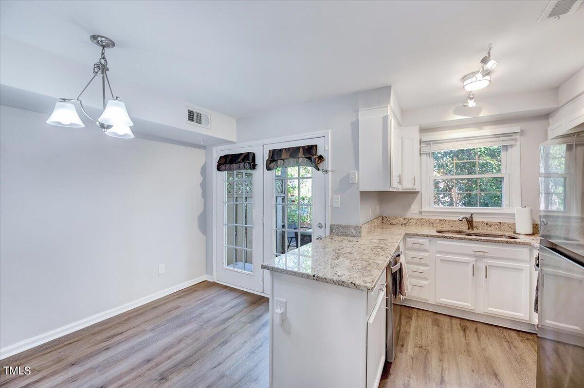 4808 Blue Bird Court, Unit D Raleigh, NC 27606 - Photo 14 of 31 a kitchen with a sink cabinets and window