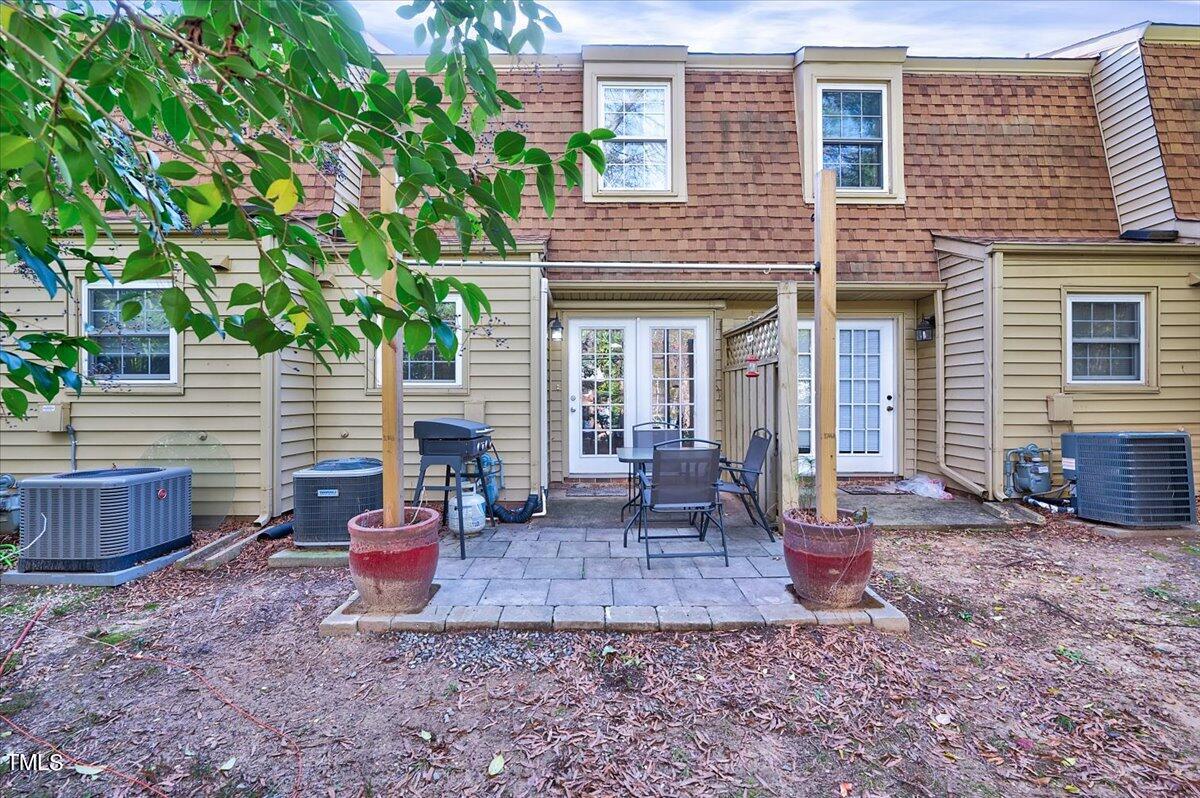 4808 Blue Bird Court, Unit D Raleigh, NC 27606 - Photo 22 of 31 a view of a house with chairs and table in a patio