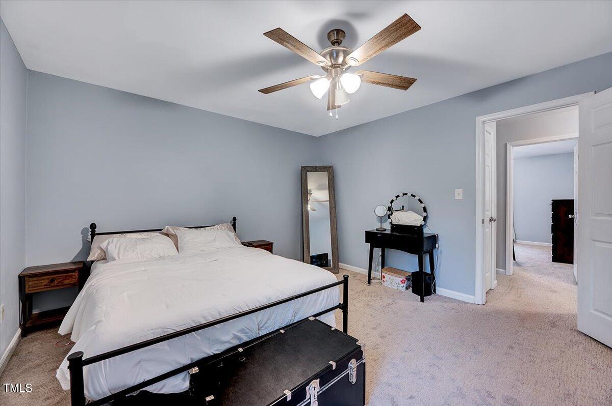 4808 Blue Bird Court, Unit D Raleigh, NC 27606 - Photo 4 of 31 a bedroom with a bed and a table in it