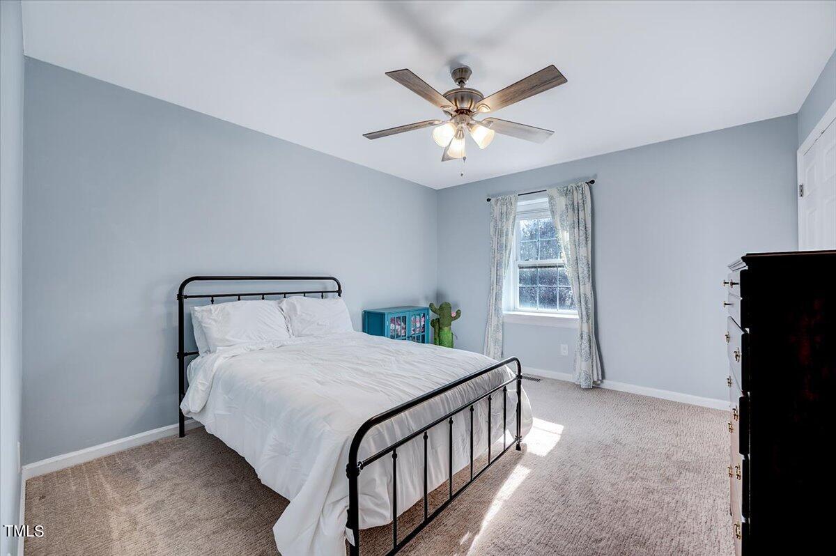 4808 Blue Bird Court, Unit D Raleigh, NC 27606 - Photo 5 of 31 a bedroom with a bed and a window