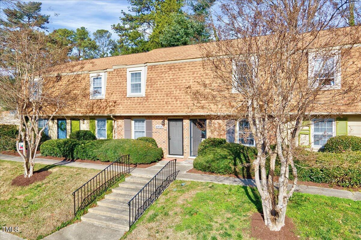 4808 Blue Bird Court, Unit D Raleigh, NC 27606 - Photo 6 of 31 a front view of a house with garden