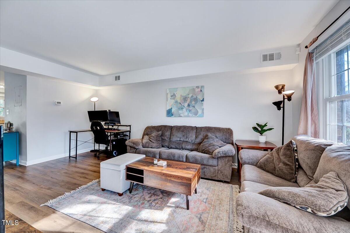 4808 Blue Bird Court, Unit D Raleigh, NC 27606 - Photo 7 of 31 a living room with furniture and a couch