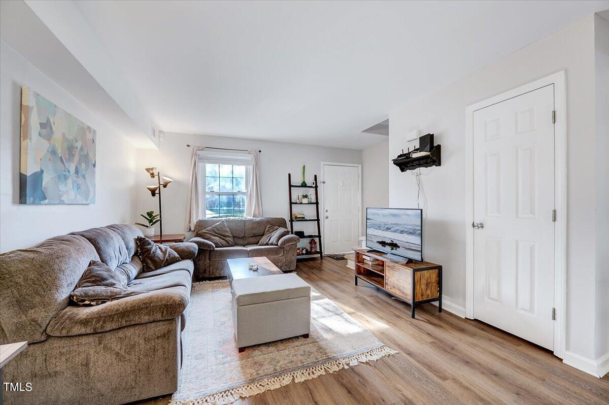 4808 Blue Bird Court, Unit D Raleigh, NC 27606 - Photo 9 of 31 a living room with furniture and a flat screen tv