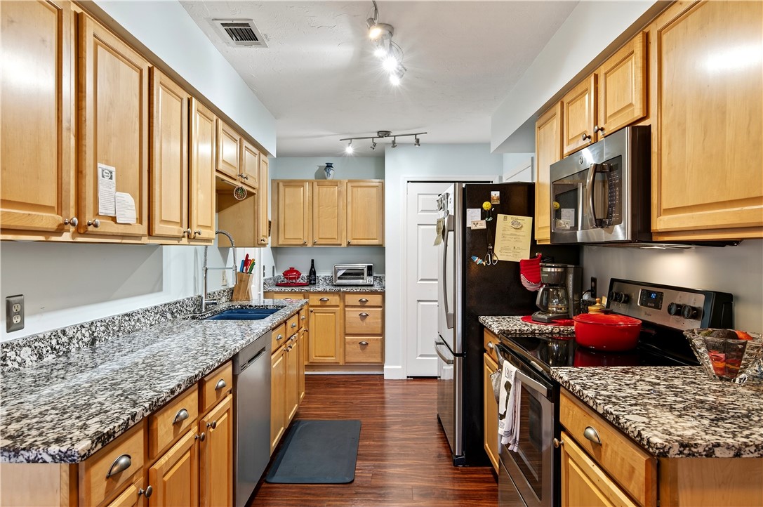725 Timber Ridge Trail Southwest, Unit B Vero Beach, FL 32962 - Photo 12 of 36 a kitchen with stainless steel appliances granite countertop a sink stove and refrigerator