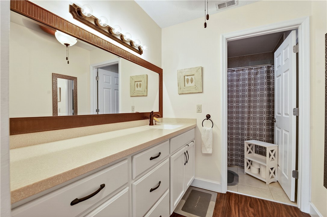 725 Timber Ridge Trail Southwest, Unit B Vero Beach, FL 32962 - Photo 12 of 27 a spacious bathroom with a sink a mirror and a shower