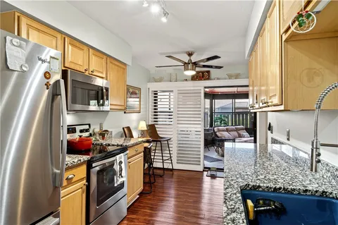 a kitchen with stainless steel appliances granite countertop a stove and a sink