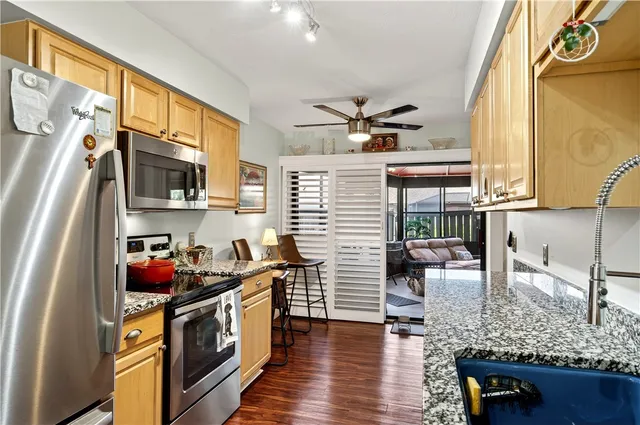 a kitchen with stainless steel appliances granite countertop a stove and a sink