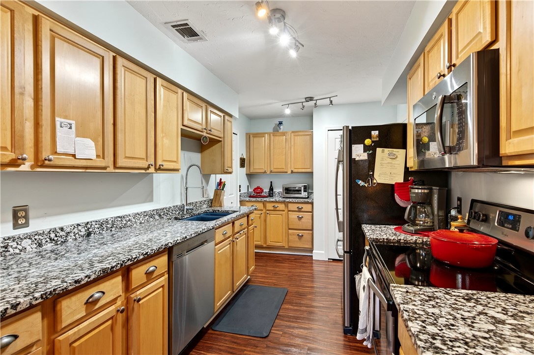 725 Timber Ridge Trail Southwest, Unit B Vero Beach, FL 32962 - Photo 14 of 36 a kitchen with stainless steel appliances granite countertop a sink and cabinets