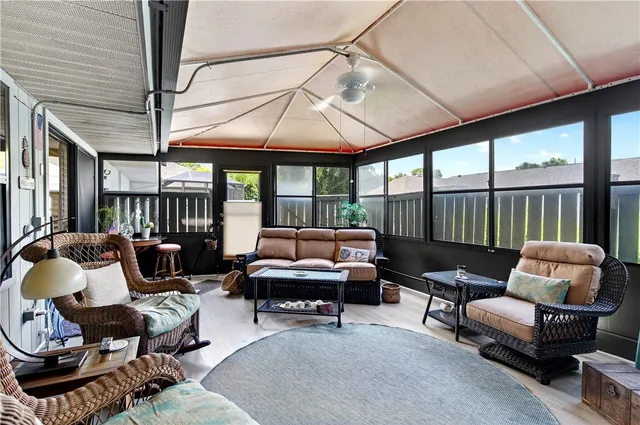 a outdoor living space with furniture and a ceiling fan