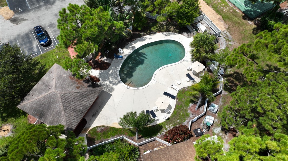 725 Timber Ridge Trail Southwest, Unit B Vero Beach, FL 32962 - Photo 23 of 27 an aerial view of a house with a swimming pool and outdoor seating