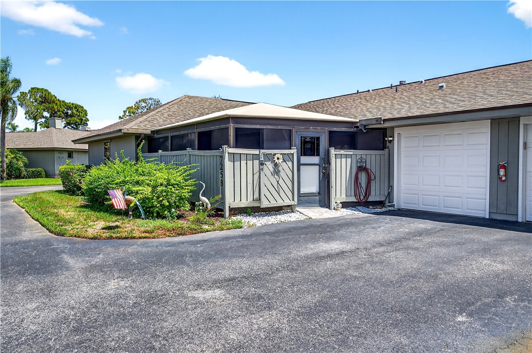 725 Timber Ridge Trail Southwest, Unit B Vero Beach, FL 32962 - Photo 27 of 36 a front view of a house with a yard