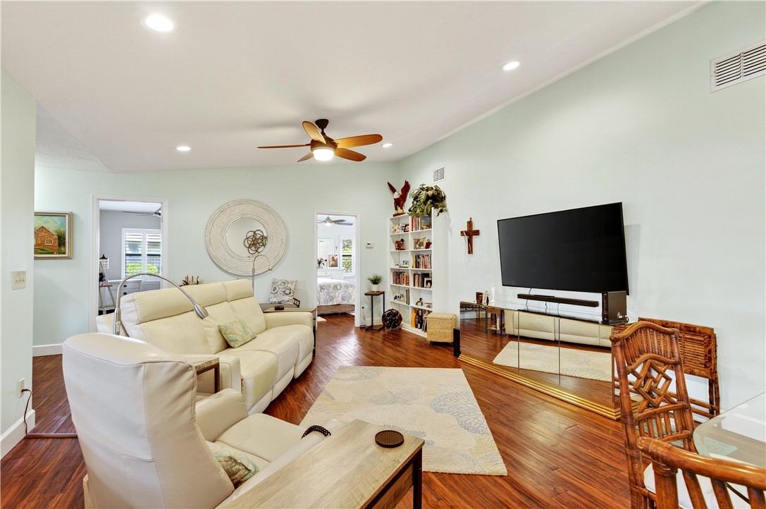 725 Timber Ridge Trail Southwest, Unit B Vero Beach, FL 32962 - Photo 3 of 27 a living room with furniture and a flat screen tv