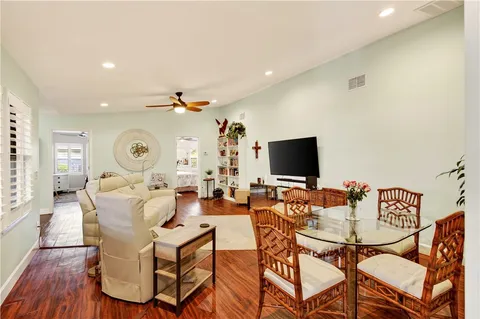 a living room with couches and a flat screen tv