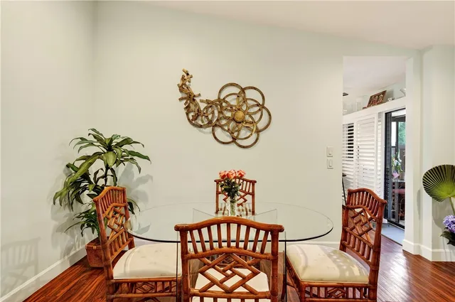 a view of a dining room with furniture and wooden floor