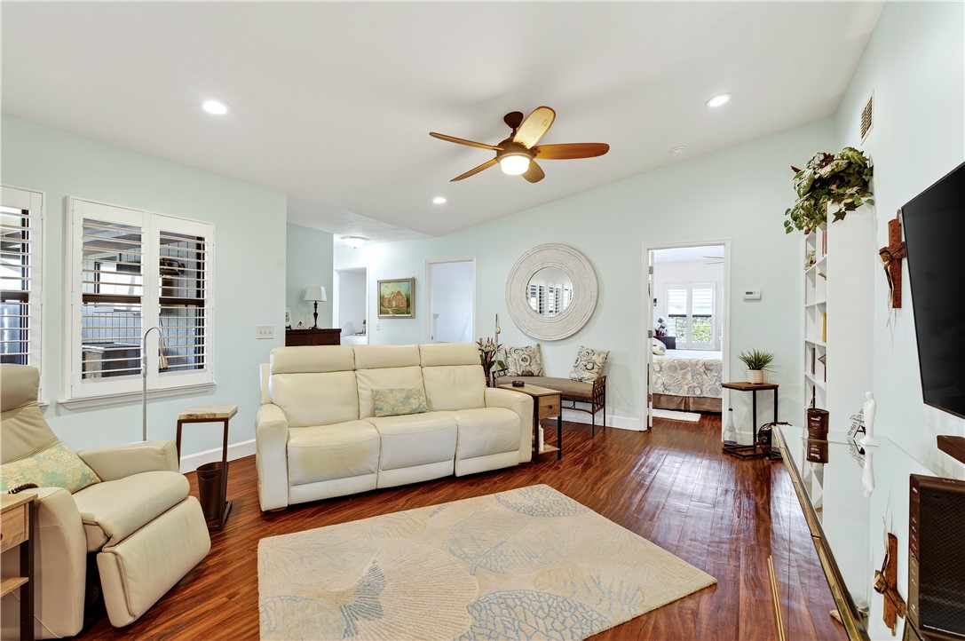 725 Timber Ridge Trail Southwest, Unit B Vero Beach, FL 32962 - Photo 6 of 27 a living room with furniture a fireplace and a flat screen tv