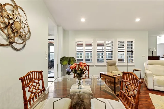 a living room with furniture and floor to ceiling windows
