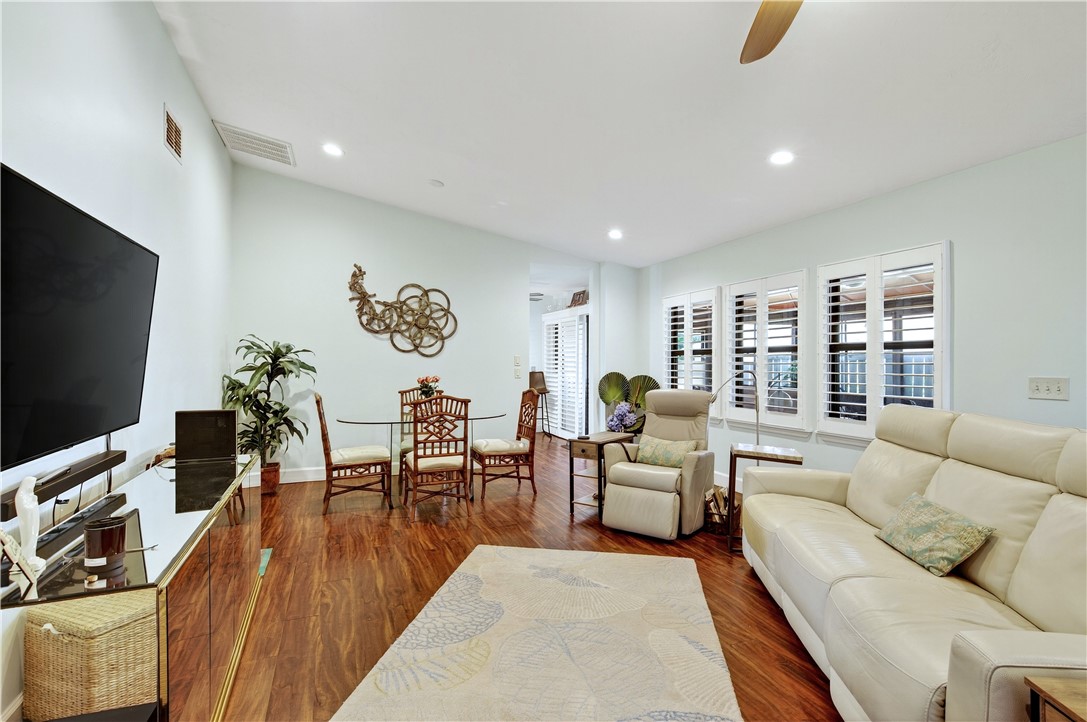 725 Timber Ridge Trail Southwest, Unit B Vero Beach, FL 32962 - Photo 7 of 27 a living room with furniture and a flat screen tv