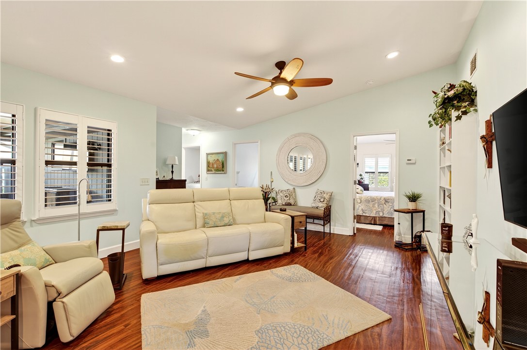 725 Timber Ridge Trail Southwest, Unit B Vero Beach, FL 32962 - Photo 8 of 36 a living room with furniture a fireplace and a flat screen tv
