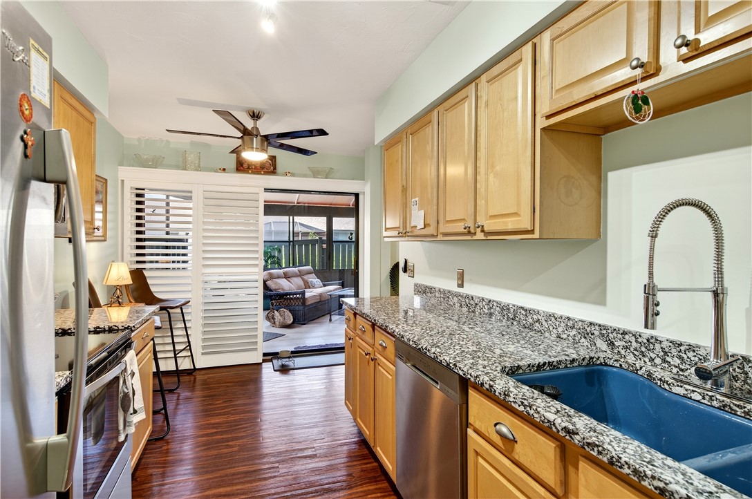 725 Timber Ridge Trail Southwest, Unit B Vero Beach, FL 32962 - Photo 10 of 27 a kitchen with sink cabinets and wooden floor