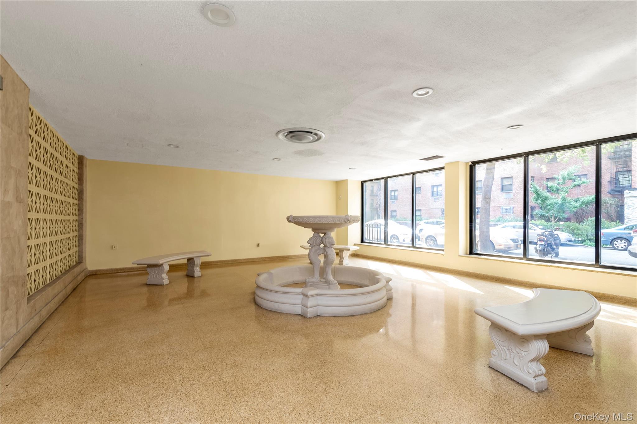 99-05 59th Avenue, Unit 6B Queens, NY 11368 - Photo 12 of 15 a view of a room with gym equipment and a fireplace