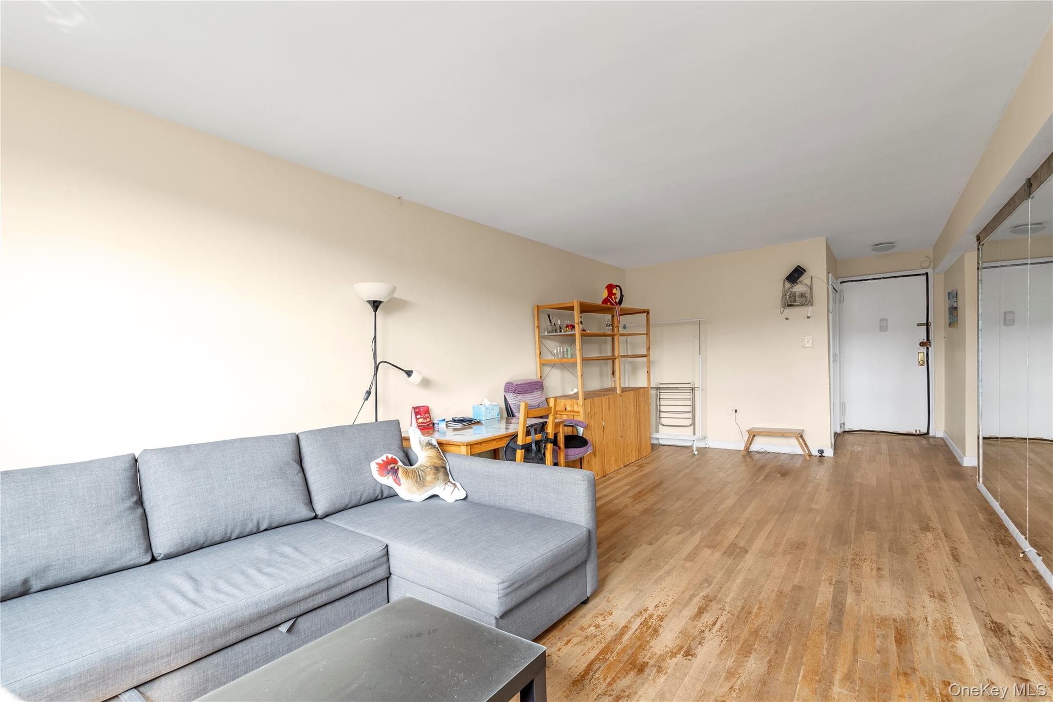 99-05 59th Avenue, Unit 6B Queens, NY 11368 - Photo 3 of 15 a living room with furniture and a wooden floor