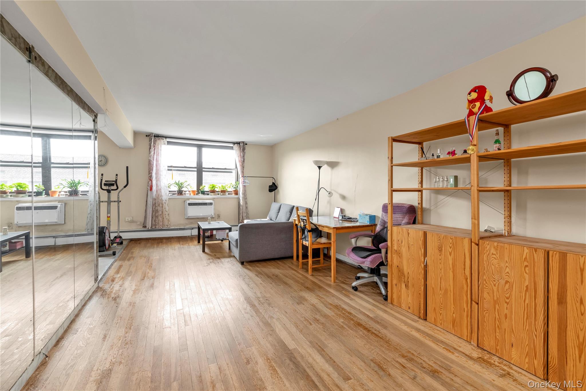 99-05 59th Avenue, Unit 6B Queens, NY 11368 - Photo 5 of 15 a view of a livingroom with furniture and a window