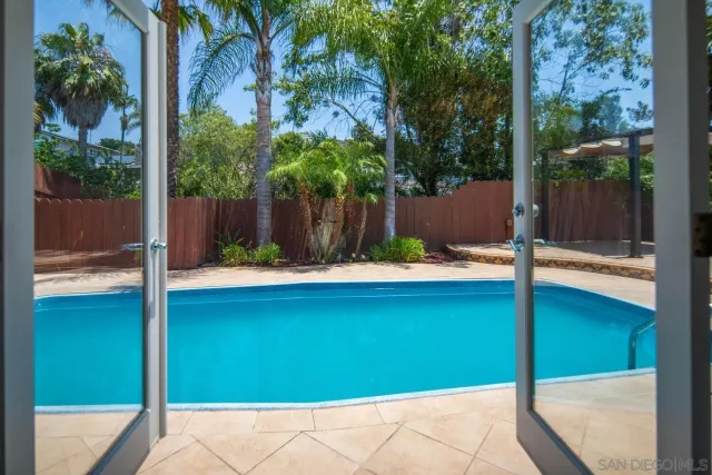 a view of a house with swimming pool and sitting area