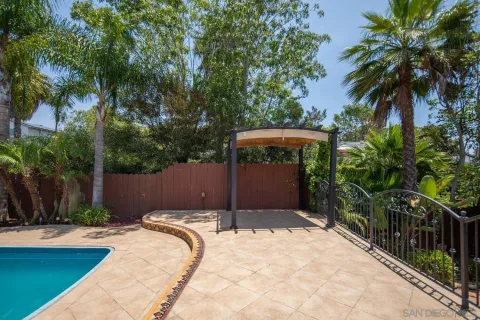 a view of a house with backyard and sitting area