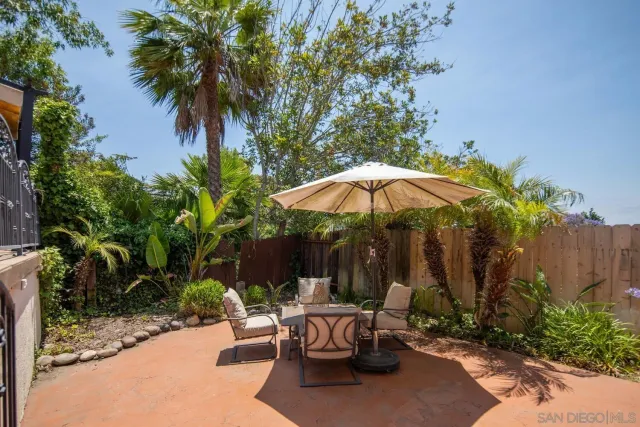 a view of backyard with outdoor seating and plants