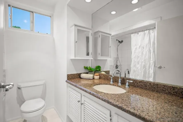 a bathroom with a bath tub with a shower