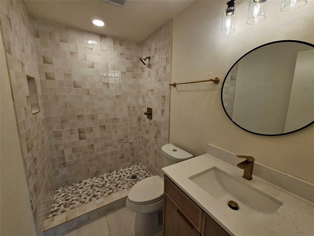 1725 R Avenue, Unit 1725 Plano, TX 75074 - Photo 14 of 20 Contemporary bathroom featuring a walk-in shower with mosaic wall tile and pebble floor