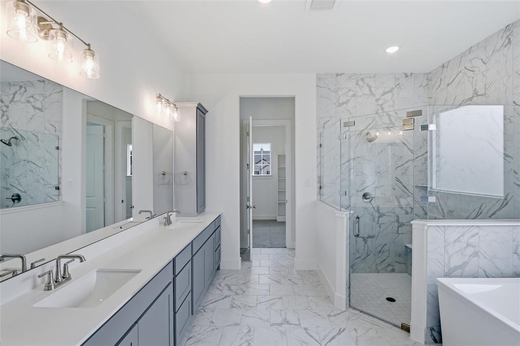 808 Vly Rdg Road Van Alstyne, TX 75495 - Photo 23 of 39 a spacious bathroom with a shower sink and mirror