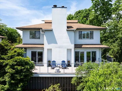 a view of house with a swimming pool and outdoor seating