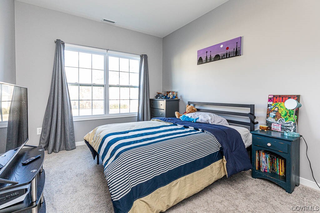 11100 Avening Road Midlothian, VA 23112 - Photo 20 of 29 a bedroom with a bed a dresser and a flat screen tv