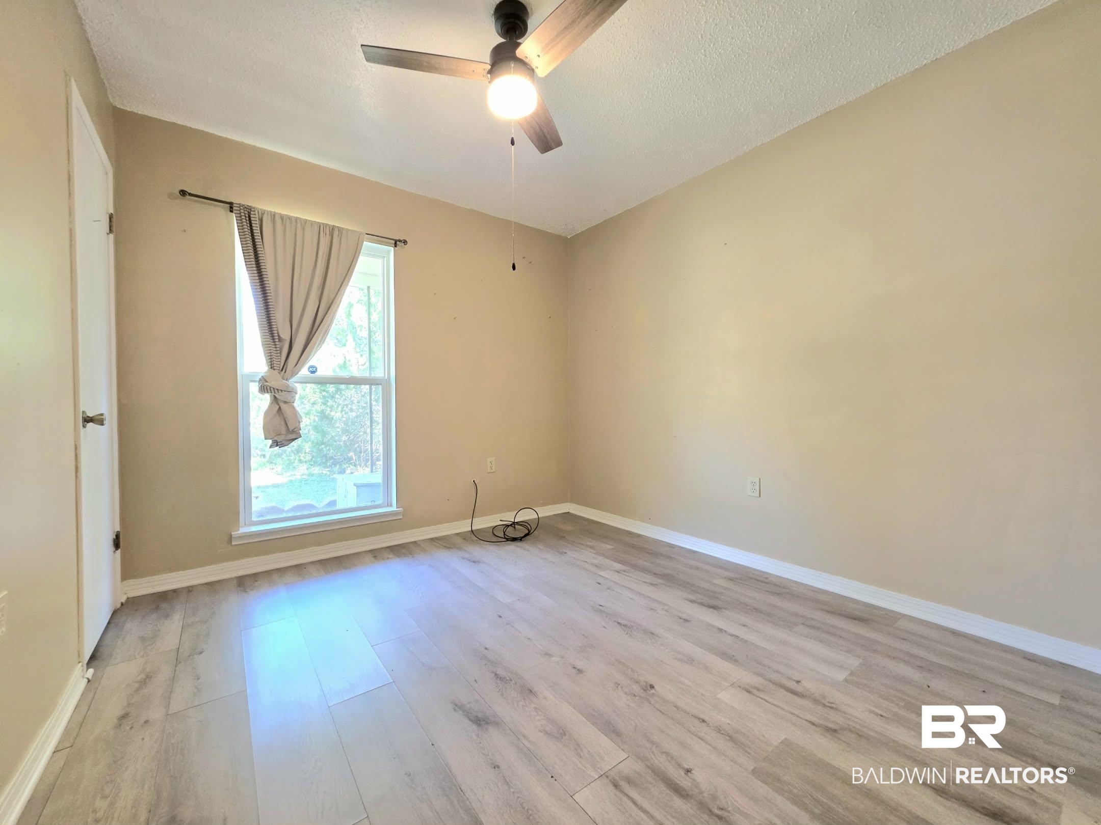 11 Coal Fire Road Jackson, AL 36545 - Photo 22 of 23 Empty room with light wood-style flooring, ceiling fan, and a textured ceiling
