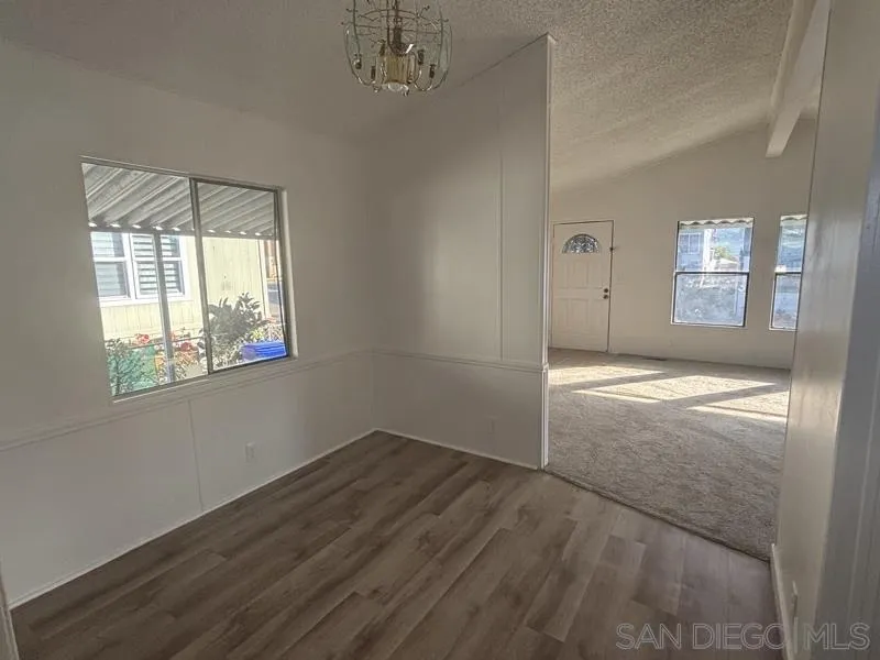 2515 Sweetwater Road, Unit 81 Spring Valley, CA 91977 - Photo 3 of 24 an empty room with windows and entrance