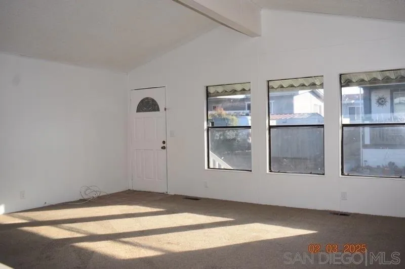 2515 Sweetwater Road, Unit 81 Spring Valley, CA 91977 - Photo 4 of 24 a view of empty room with window and cabinet
