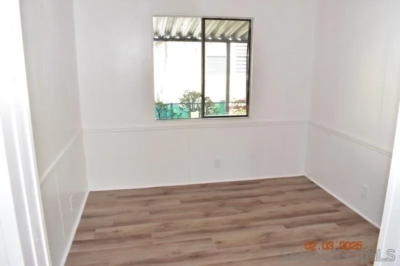 2515 Sweetwater Road, Unit 81 Spring Valley, CA 91977 - Photo 6 of 24 a view of a small space with wooden floor and a window