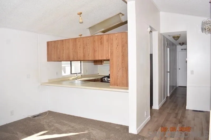 2515 Sweetwater Road, Unit 81 Spring Valley, CA 91977 - Photo 8 of 24 a view of a kitchen with wooden floor and a window