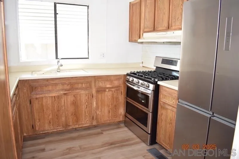 2515 Sweetwater Road, Unit 81 Spring Valley, CA 91977 - Photo 10 of 24 a kitchen with granite countertop a sink and a stove