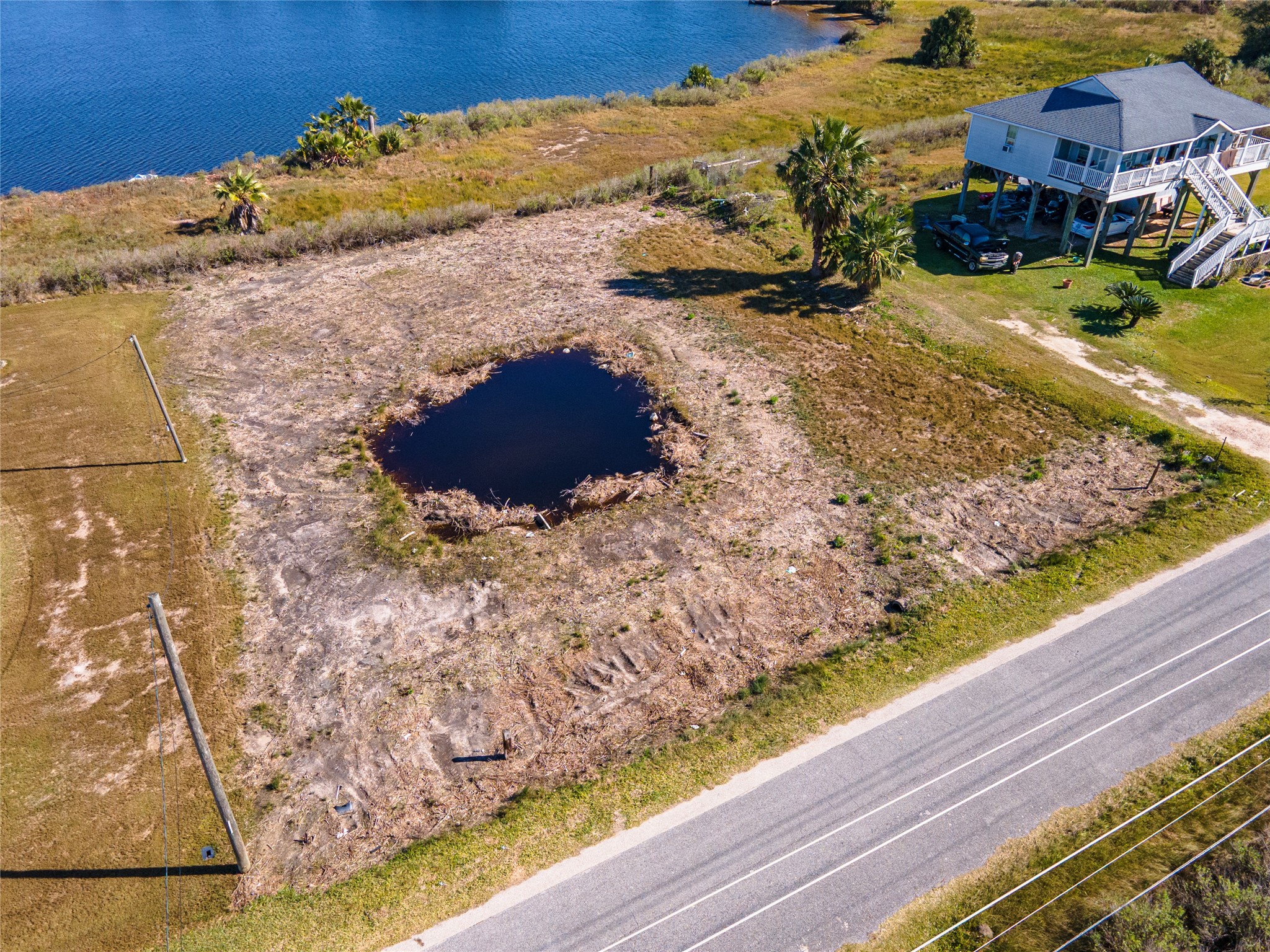 10 Mile Road Galveston, TX 77554 - Photo 2 of 12 a view of a yard with wooden fence
