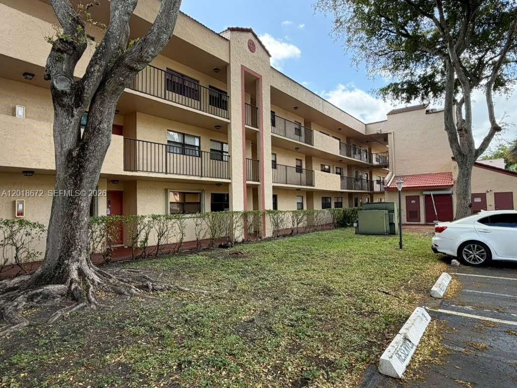 3400 Foxcroft Road, Unit 107 Miramar, FL 33025 - Photo 1 of 15 a view of a yard in front of a house