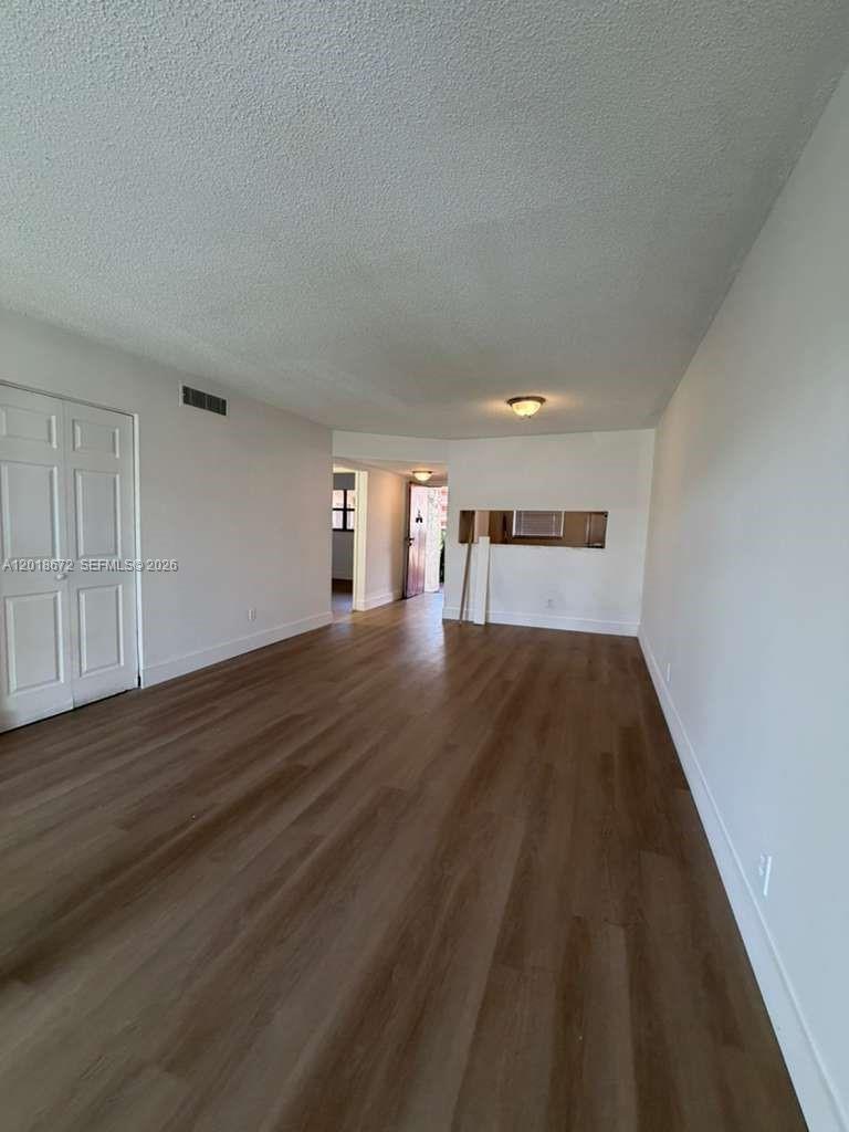 3400 Foxcroft Road, Unit 107 Miramar, FL 33025 - Photo 2 of 15 a view of empty room with wooden floor